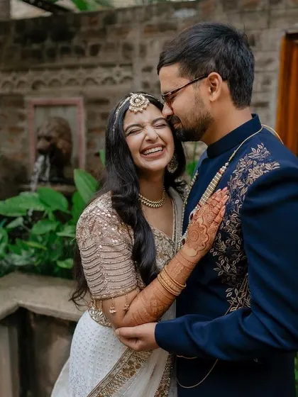 A tender moment during the sangeet night. The soft lighting and genuine smiles create a warm and romantic atmosphere, perfect for capturing the couple's love story.