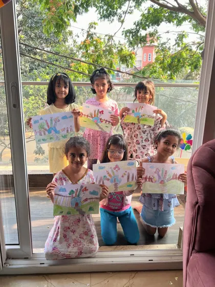 A whole class of proud artists showing off their "Hand House" drawings. It's amazing how a simple hand outline can spark so much creativity.