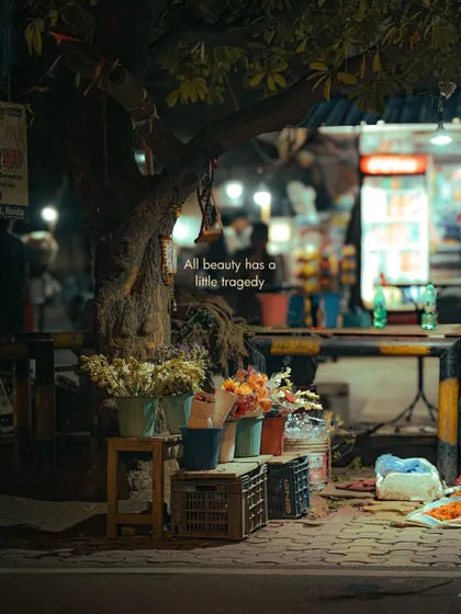 A flower seller's stall at night. The beauty of the flowers contrasts with the gritty reality of the street, a theme I find very compelling.