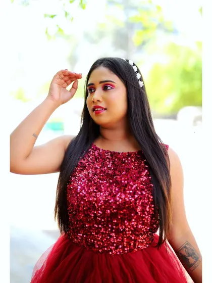 Another angle of the red sequin gown look. The bright pink eyeshadow and glowing skin are visible, showcasing a makeup style that is both fun and ready for a party.