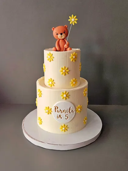 When minimal and simple is the prettiest. A two-tier chocolate cake for Parnita's 5th birthday, decorated with yellow flowers and a cute teddy bear.