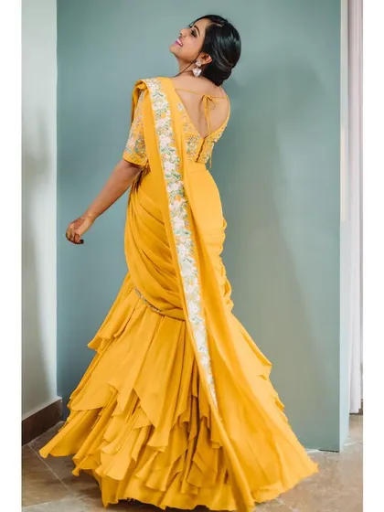This back view is crucial for showing the 360-degree design of the garment, including the elegant cut of the blouse and the embroidery along the pallu.