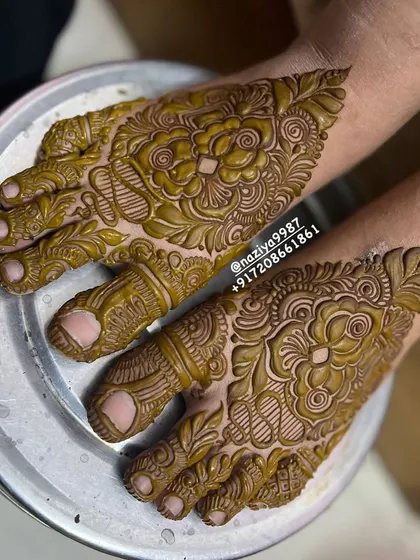 A close-up of the feet of the engagement bride. The design is just as detailed and beautiful as the henna on her hands.