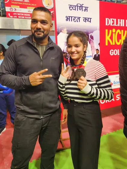 Another victory for the team. Posing with a student and her well earned medal.