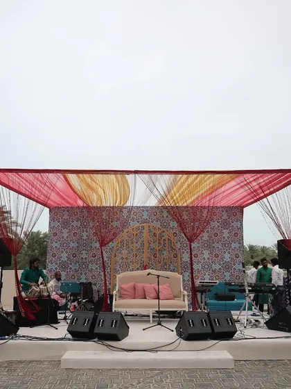 The outdoor stage for a musical evening in Bahrain, with a backdrop of intricate Moroccan patterns, ready for a night of entertainment under the stars.