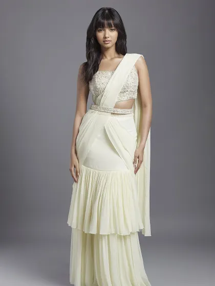 A beautiful ivory sharara-saree with a tiered skirt, a graceful and elegant option for a daytime event.