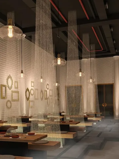 A design for a different kind of lounge, with a more relaxed and artistic feel. This space features low seating, sheer curtains for privacy, and walls adorned with empty golden frames for a quirky, eclectic vibe.