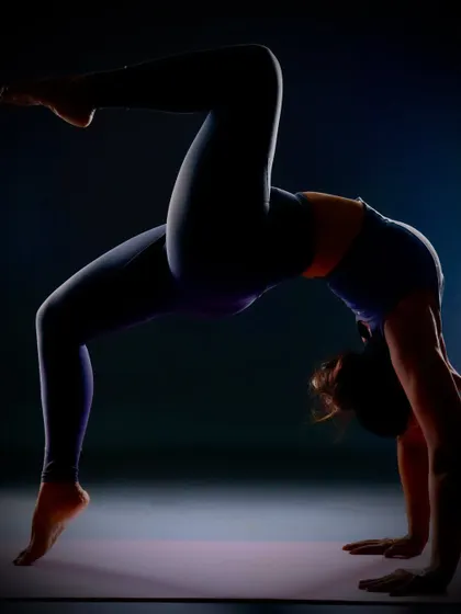 I am not what happened to me, I am what I choose to become. This dramatic, silhouetted wheel pose variation from a photoshoot represents the strength and resilience we cultivate through our practice.