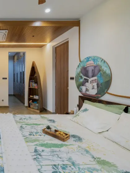 A unique boat-shaped bookshelf adds a touch of playful creativity and personalized storage to the master bedroom.