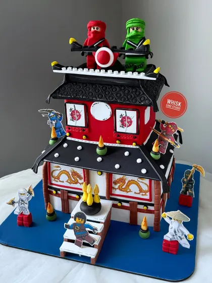 An intricate Ninjago castle cake for a young warrior. This detailed cake is a complete, edible replica of a Ninjago monastery, with all the ninja characters included.