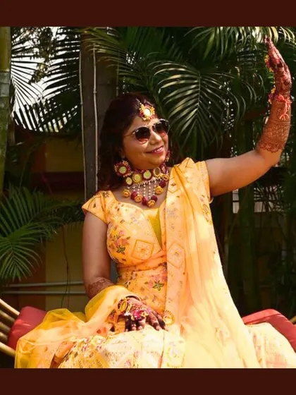 The bride looks radiant in her custom yellow Haldi lehenga. I designed it to be bright, comfortable, and perfect for the joyous celebration.