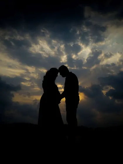 Sometimes the most powerful moments are the quiet ones. I love taking couples outdoors for a natural light session, creating romantic silhouettes like this against the evening sky.