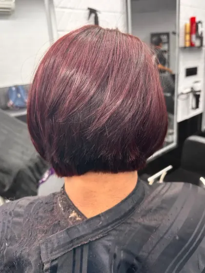 A chic and powerful statement with this short bob haircut in a rich, burgundy red color. The sleek cut and bold color create a truly unforgettable style.