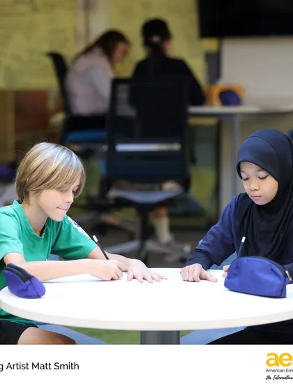 Two students collaborate on a drawing exercise during a workshop. We foster a collaborative learning environment where students can learn from both the visiting artist and each other.