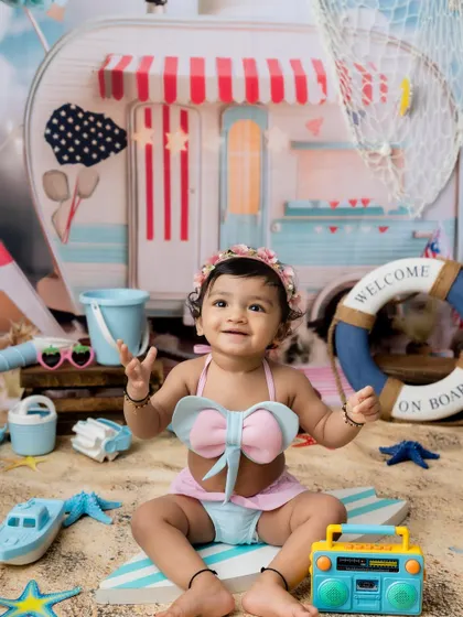Clapping her hands with joy! This little girl loved her beach-themed photoshoot.