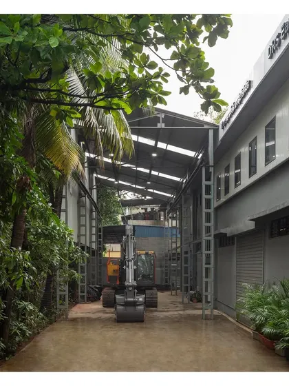 An exterior view of the 10,000 sq ft industrial facility. The design clearly separates pedestrian and machinery movement, ensuring safety and operational efficiency.