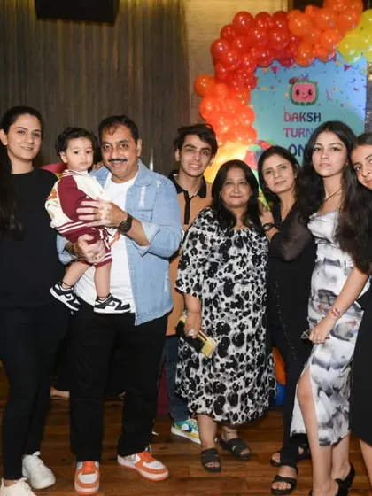 A large group photo capturing all the friends and family who came to celebrate the first birthday.