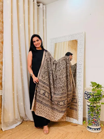 Another way to style a basic black suit is with this beige and black hand-block printed dupatta. It creates a very sophisticated and earthy look.