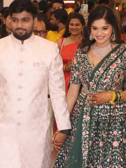 Walking hand-in-hand. This look shows how a soft glam makeup style can perfectly complement a richly detailed engagement lehenga.