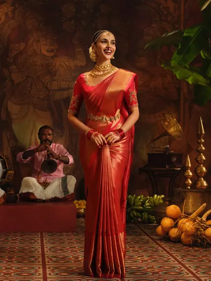 A full-length view of the stunning red silk saree from the Pothys shoot. The drape is designed to create a powerful and graceful silhouette.