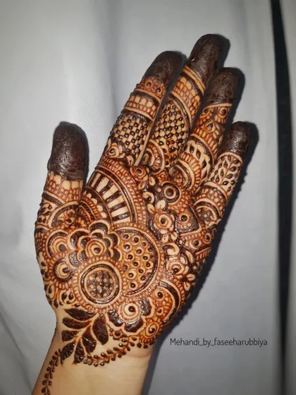 An intricate design perfect for any celebration, showcasing detailed finger work and a central palm motif.