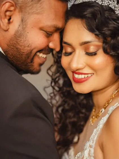 A close-up of Janice's stunning bridal look. Her bold red lip is the perfect complement to her defined curls and glowing skin.