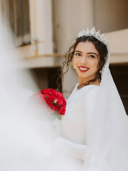 A bride's elegance is in her grace. This beautiful shot through the veil captures her serene beauty and classic style.