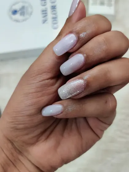 Nude nails are always a winning choice. This set features a soft, milky lavender polish with a single silver glitter accent nail for a chic and understated manicure.