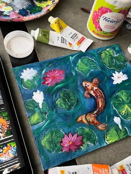 The finished acrylic painting of a koi fish pond on canvas. I used reference images to capture the graceful movement of the fish and the serene quality of the water with its lily pads and flowers.