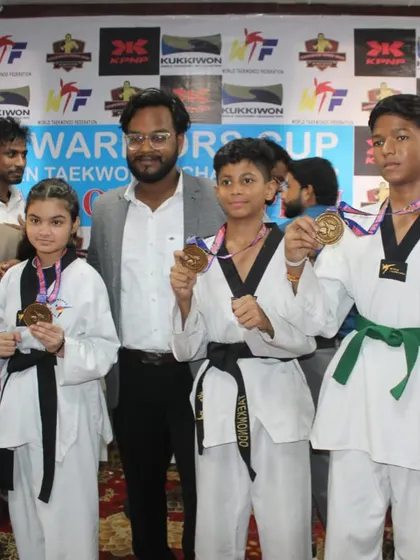 Posing with some of my dedicated students and their medals. I train athletes of all belt levels, from green to black, for competitive success.