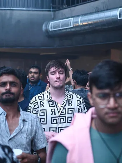 A man with his eyes closed, deeply feeling the music. A moment of transcendence on the dance floor.