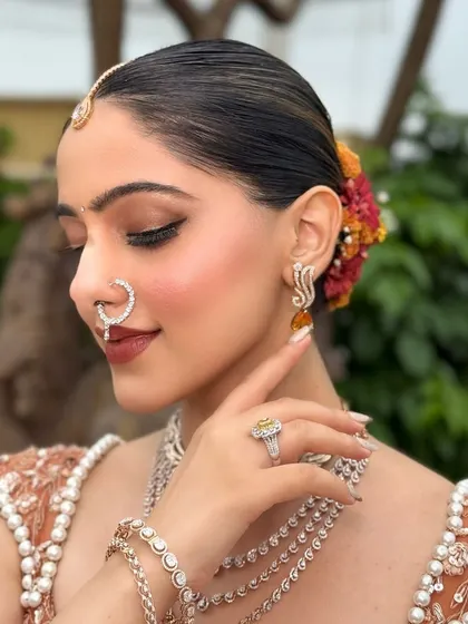 Another angle of the elegant floral bun and the flawless profile. The makeup is set to last all day, from the morning ceremony to the evening celebrations.