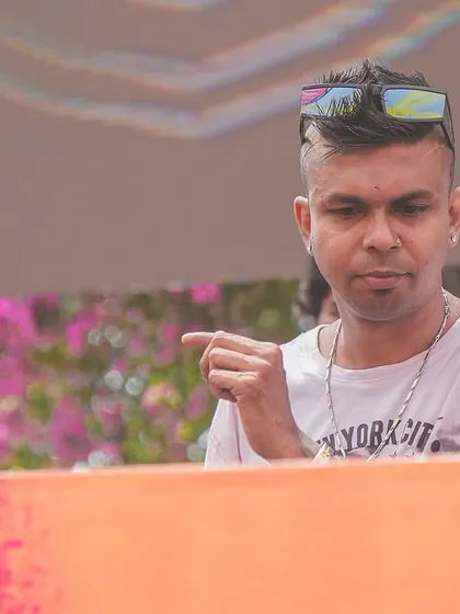 Cueing up the next banger for the festival crowd. A close-up shot of me at the decks during the vibrant Holi celebration.