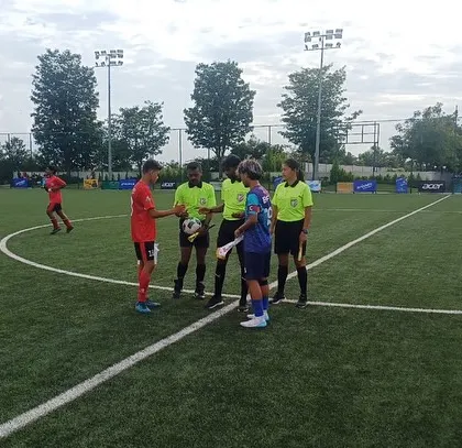 The coin toss ceremony at the center of the pitch.