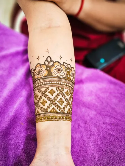 A close-up of the armband, featuring a band of delicate roses.