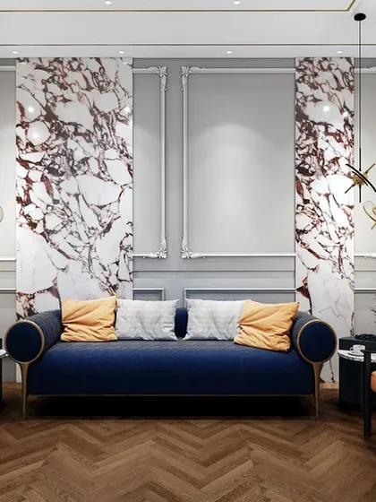 The waiting lounge for the lawyer's office, featuring a bold blue sofa, orange accent chairs, and dramatic marble panels. The design is contemporary, comfortable, and visually striking.