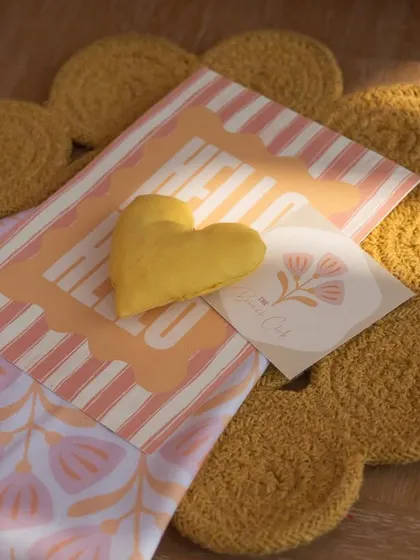 A close-up of the thoughtful details, including a custom menu, a heart-shaped cushion, and a flower-shaped placemat.