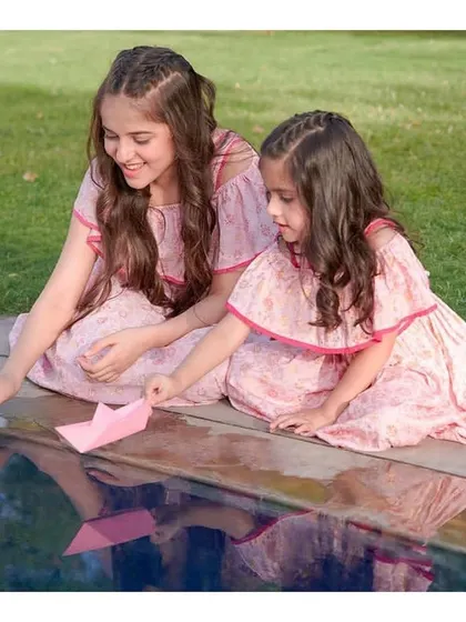 This outdoor shot for the kid's wear brand shows the makeup in natural daylight. The subtle touches ensure the models look naturally radiant and camera-ready for the campaign.