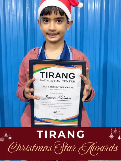 A young player proudly holds his "Ace Badminton Award" during our Christmas celebrations. Recognizing effort and sincerity helps build a strong foundation for lifelong success.