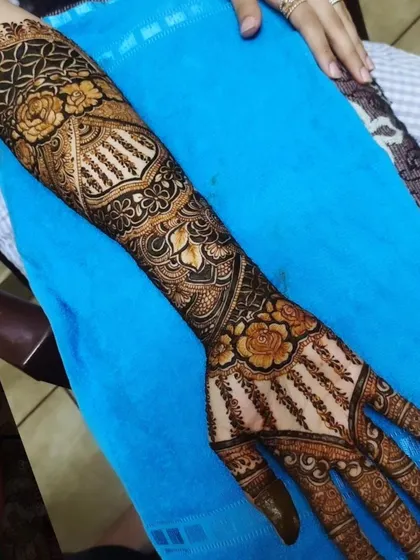A close-up of a full-arm design, showing the detail and precision in every element, from the fingertips to the elbow.
