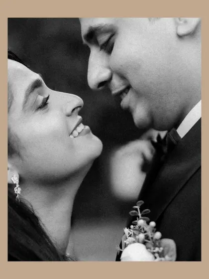 A classic black and white portrait that feels timeless. The soft smiles and close embrace between the couple create a feeling of warmth and genuine affection.