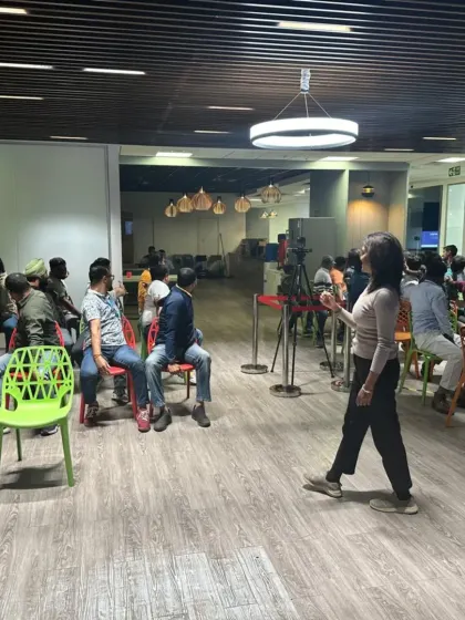 Addressing the group during a wellness at work session, creating a space for open dialogue and learning.
