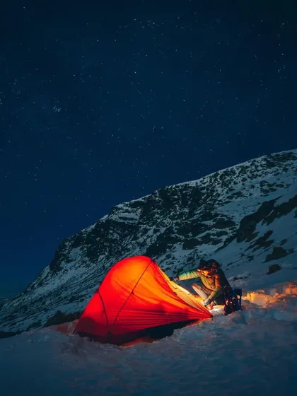 For the more adventurous soul, I plan trips to the high mountains. Here, a glowing tent offers a warm sanctuary under a sky full of stars, surrounded by the silent majesty of snow. This is an unforgettable winter camping experience.