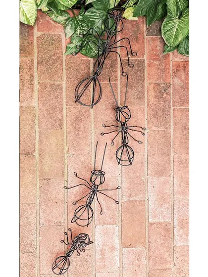 These wireframe ant sculptures, crafted from recycled materials, climb a brick path in our studio. They represent teamwork and persistence, values that are central to our architectural practice.