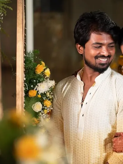 A sweet, candid moment between the couple, surrounded by beautiful marigold decorations at their Haldi ceremony.