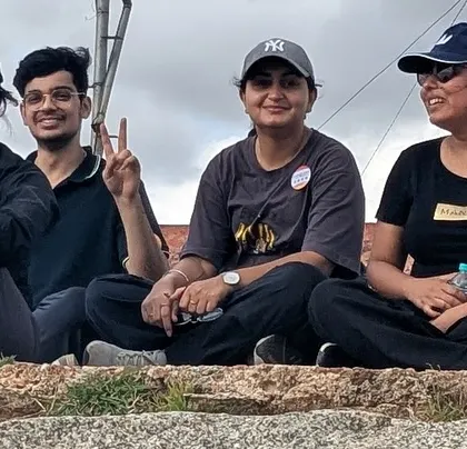 Relaxing at the top after a small hike during our Adiyogi day trip. The trip combines spiritual sites with beautiful natural landscapes.