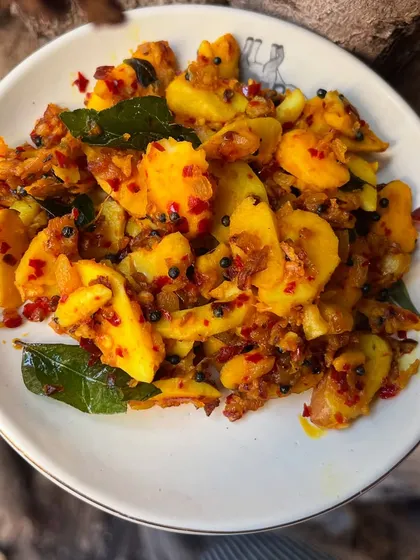A closer look at the jackfruit seed stir-fry. The seeds are cooked with red chili flakes, mustard seeds, and curry leaves, creating a dish that is both rustic and delicious.