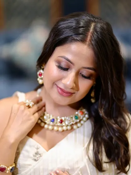 A close-up of the client looking down, showcasing the soft and blended eyeshadow.