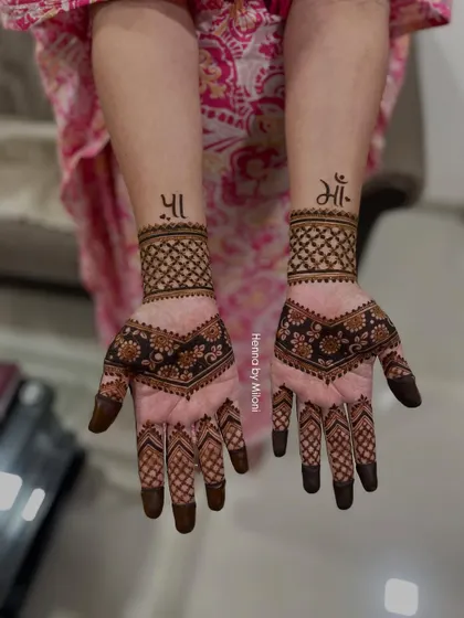 A beautiful tribute to mothers. This design features the word "Maa" (Mother) on both wrists, surrounded by elegant patterns.
