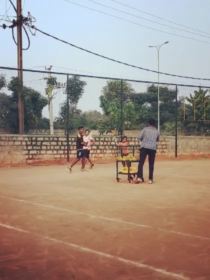 A group training session in progress, seen from a wide angle that captures the court environment.